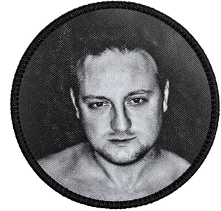 Round black-and-white face patch sewn on the sleeve